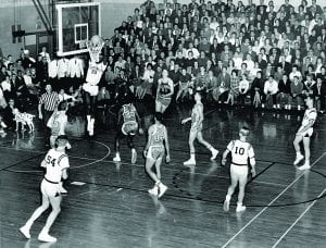 John Thompson, Jr. ’64 slams the ball home in a game against St. Louis University in Alumni Hall during the 1962-63 season.