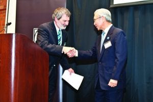 Dr. Richard M. Battistoni, director of the Feinstein Institute, left, greets Dr. Michael Thio, president general of the Confederation of the Society of St. Vincent de Paul, at the institute’s Hall of Heroes induction. Thio accepted the posthumous honor on behalf of inductee Blessed Frederic Ozanam, the founder of the society.