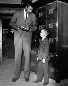 Jim Hadnot ’62, a 6-foot 10-inch center, signs an autograph before his second varsity game, against Brown University in December 1959.