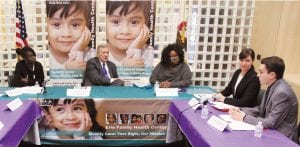 U.S. Sen. Richard J. Durbin, D-Ill., second from left, and Emily A. Benfer ’99, second from right, meet with Health Justice Project partners in October 2016 to discuss lead paint poisoning in federally-assisted housing. With them are, from left, project clients Lanice Walker and Tolanda McMullen, whose children experienced lead poisoning, and Ethan Domsten, a law student with the project. (Photo by Dexter Watt)