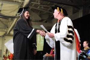 Father Shanley presents an award at the Academic Awards Ceremony. 