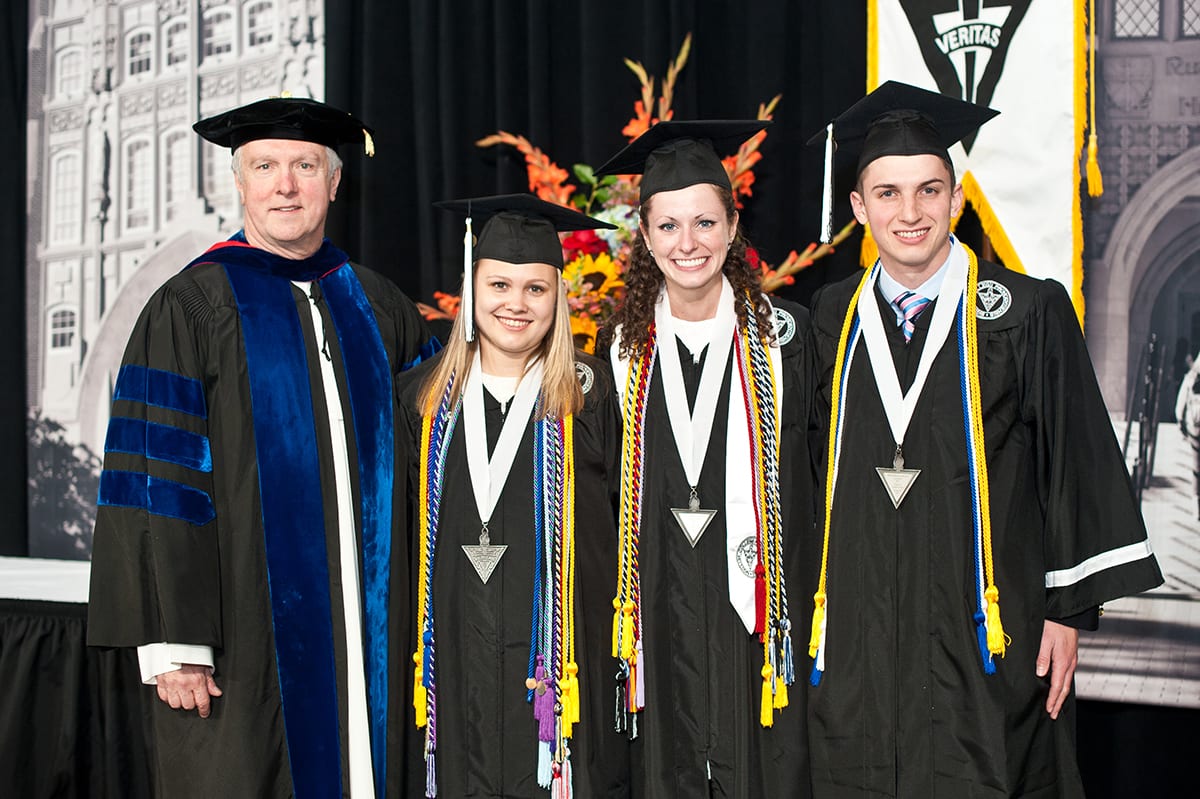 Lauren Berolini '17, second from left, with, from left, Rev. Mark D. Nowel, O.P., dean of undergraduate and graduate studies, Victoria Timmel '17, and Jack Ricci '17 at the Academic Awards Ceremony.