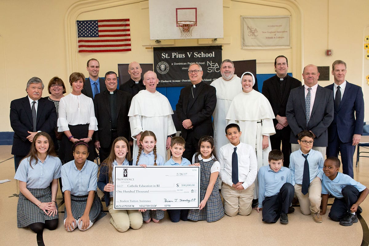 College representatives, diocesan officials, and Catholic school children at the announcement of PC's $100,000 gift.