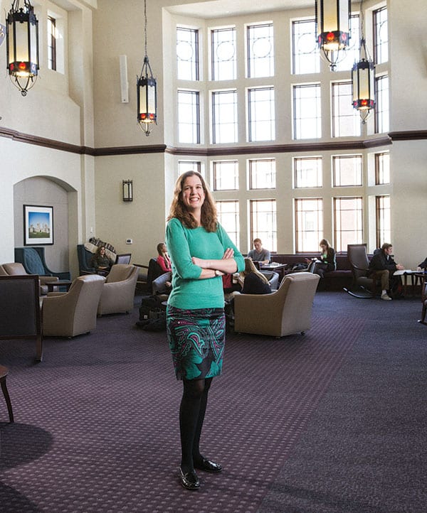 Dr. Jennifer G. Illuzzi, assistant professor of history, came to the College in 2011 and has taught in the former and revised versions of the DWC Program. She stands in the Great Room of the Ruane Center for the Humanities.