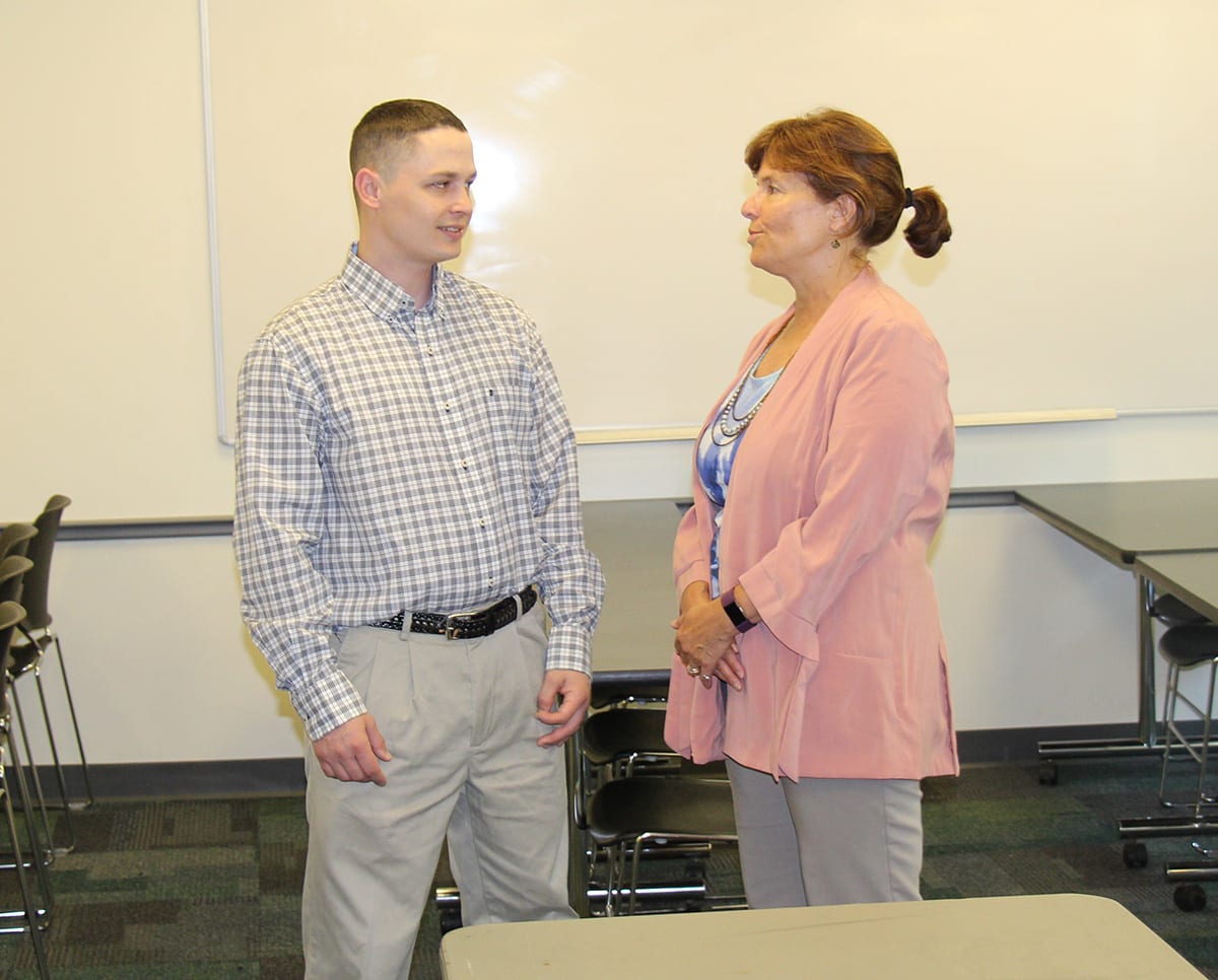 Sean Moore '17SCE speaks with his adviser, Anne Nagle, SCE assistant dean, in a Harkins Hall classroom. 