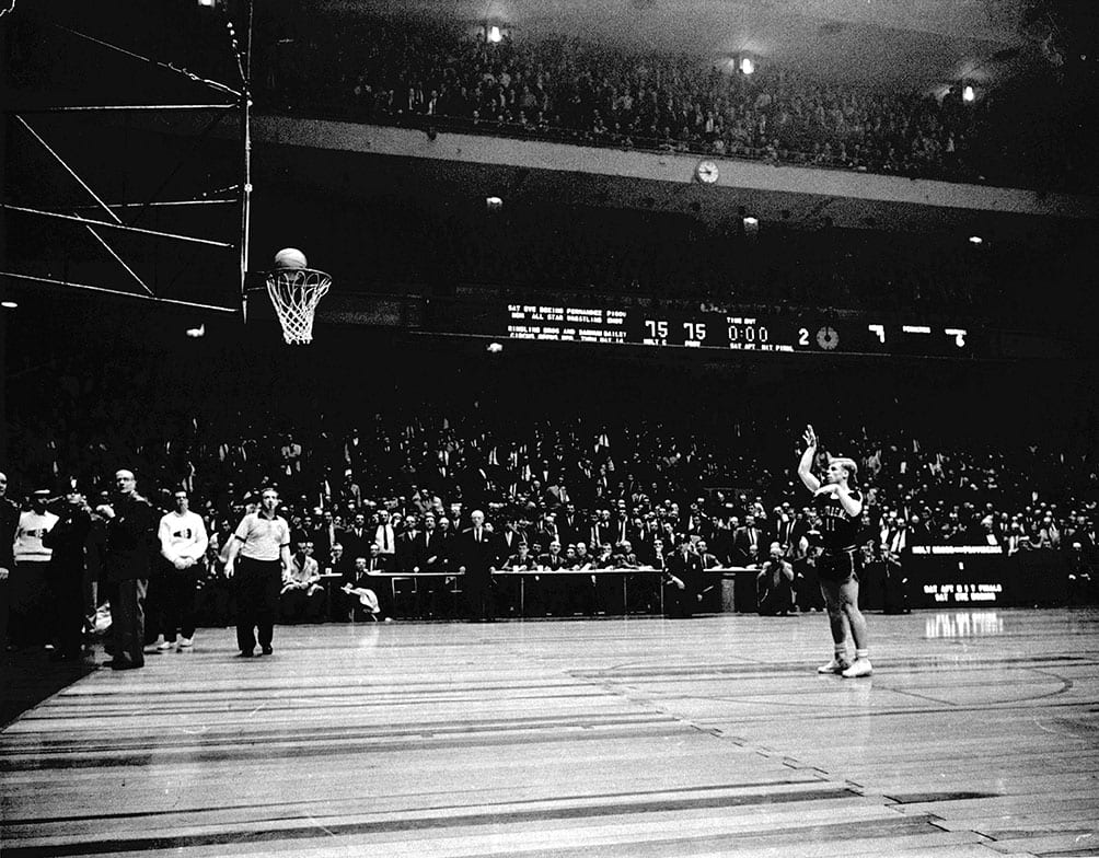 In perhaps the most legendary photograph in PC basketball history, Vinnie Ernst ’63 launches a foul shot with no time left on the clock and the score tied at 75-75 in the 1961 NIT semifinal game against Holy Cross. As Crusader fans shook the basket, the ball popped out. Ernst scored or assisted on all 15 points in overtime as the Friars won and advanced to the title contest, in which they captured their first NIT Championship by defeating St. Louis University.