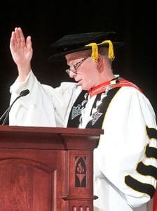 President Rev. Brian J. Shanley, O.P. '80 blesses the College pins given to the Class of 2021.