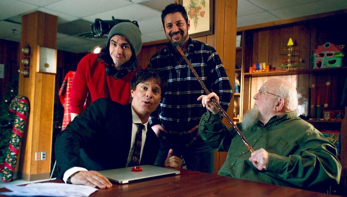 Director Tom DeNucci, front, and from left, actor Patrick Muldoon, producer David Gere ’97, and acting legend Ed Asner ham it up on the set of “The Santa Files.” (Photo: Woodhaven Media)