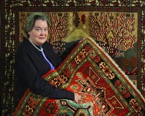 Dr. Ann W. Norton with Afghan carpets displayed at PC in 2009