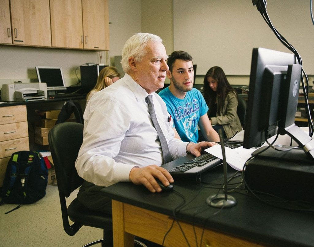 Dr. Stephen J. Mecca ’64 & ’66G, professor of physics, left, works in his campus S-Lab with Alejandro Ayala ’17. The first student experiences in the Gallo Global Health Fellowship Program will take place this summer in Ghana under Mecca’s direction. 