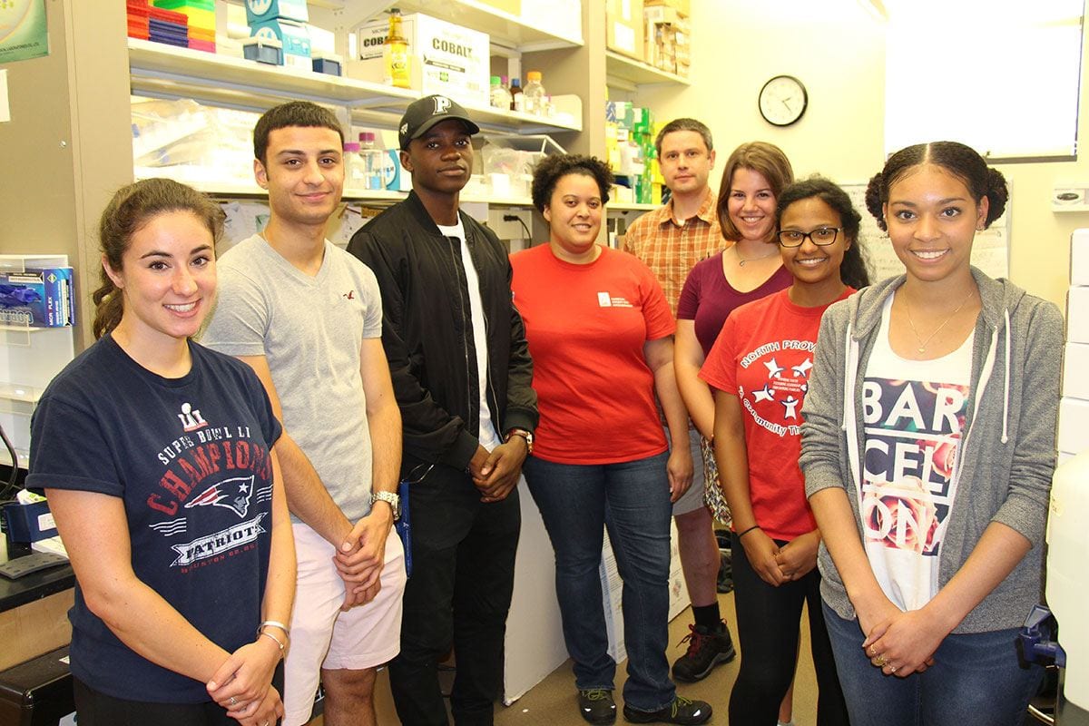 Dr. Cara Pina, fourth from left, and Dr. Brett Pellock, rear, are joined by several of their summer research students in the Pellock lab. From left are Ally Luongo ’18, Ryan Silva ’18, Dak Ojuka ’20, Alexandra Shute ’20, Nicole De La Rosa ’18, and Winifer Rosario '17.