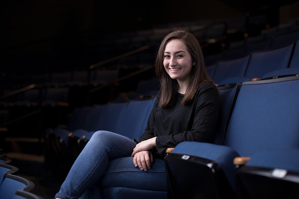 Jennifer Dorn ’18, a double major in English and theatre arts, in the seats in the Angell Blackfriars Theatre in the Smith Center for the Arts.