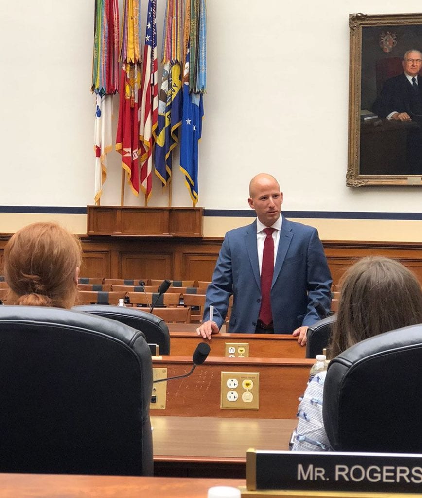 Major Michael Calcagni ’04, a legislative liaison with the U.S. House of Representatives, speaks to fellows in a House meeting room.