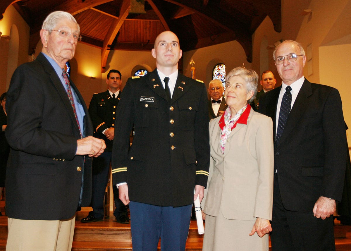 Family members join Aaron A. Rozovsky ’08, second from left, during the pinning of rank portion of the Patriot Battalion Army ROTC Commissioning Ceremony in May 2008 on campus. With him are, from left, his late great-uncle, Albert Samdperil; his mother, Fay A. (Frank) Rozovsky, J.D. '73 & '08Hon., and his late father, Lorne E. Rozovsky. Aaron was ordained a rabbi in June 2018.