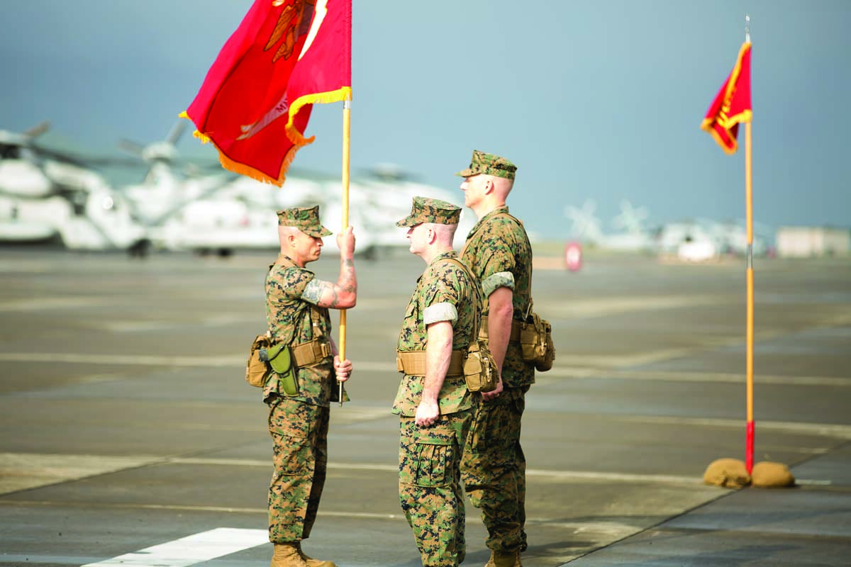 Lt. Col. Kevin G. Hunter '99, center, stands during the ceremonial passing of the squadron flag, signaling the change in command at Marine Heavy Helicopter Squadron 463 in Hawaii, in December 2017.