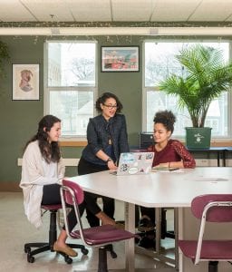 Christina Roca ’21 (left) and Junielly Vargas ’21 (right) work with Dulari Tahbildar, director of programs and partnerships at 360 High School in Providence.