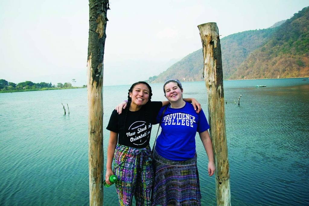 Katherine Martinez ’20, left, and Kate Corwin ’19 stand at the end of a dock on Lake Atitlán in San Lucas Tolimán.