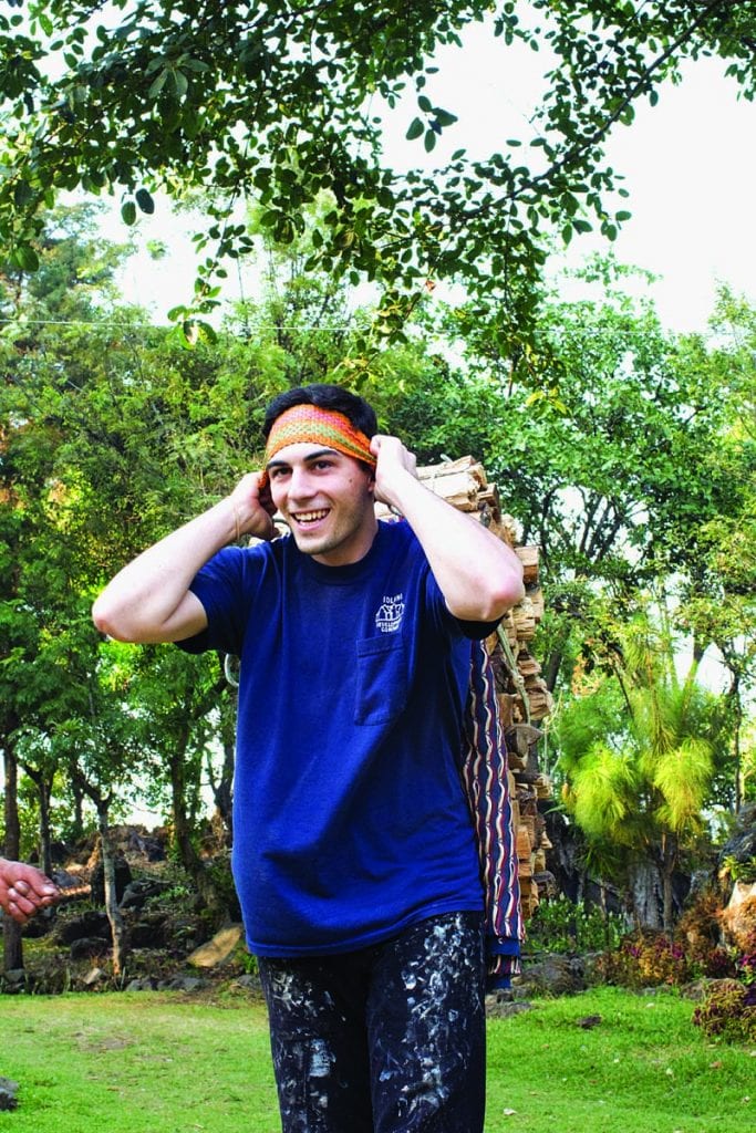 Luke Jenness '19 uses a traditional head strap to carry firewood. Highland Maya learn to carry wood this way from a young age.