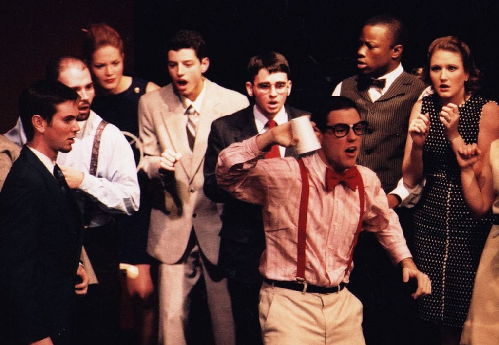 In his first year at Providence College, Dr. Troy Quinn '05 sang in musical "How to Succeed in Business Without Really Trying." He is fourth from left, in the tan suit.