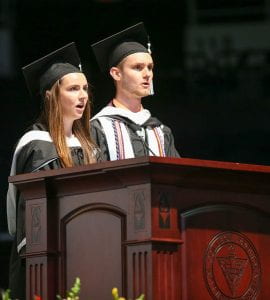 Aisling Sheahan '19, left, and Evan Brandow '19 lead the "Alma Mater" at the conclusion of commencement.