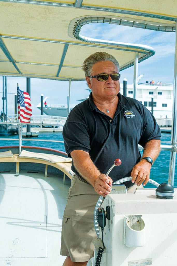 Mark S. Deresienski, O.D. ’71 navigates the shuttle boat in Newport Harbor.