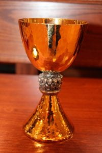 The chalice's center node depicts Christ and the apostles at the Last Supper.