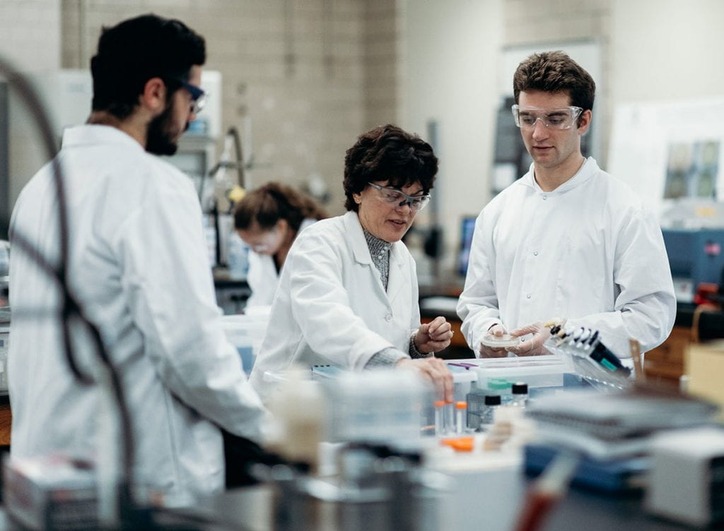 Dr. Kathleen A. Cornely, professor of chemistry, teaching in her laboratory. At right is Colby Agostino '22, one of her phage researchers. At left is Jared DiBella '22.