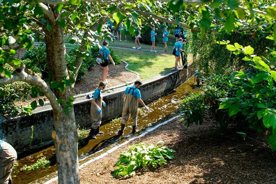 First-year students volunteering in the Urban Action program helped clean Pleasant Valley Parkway In Providence as part of a city stormwater management project taking place there.