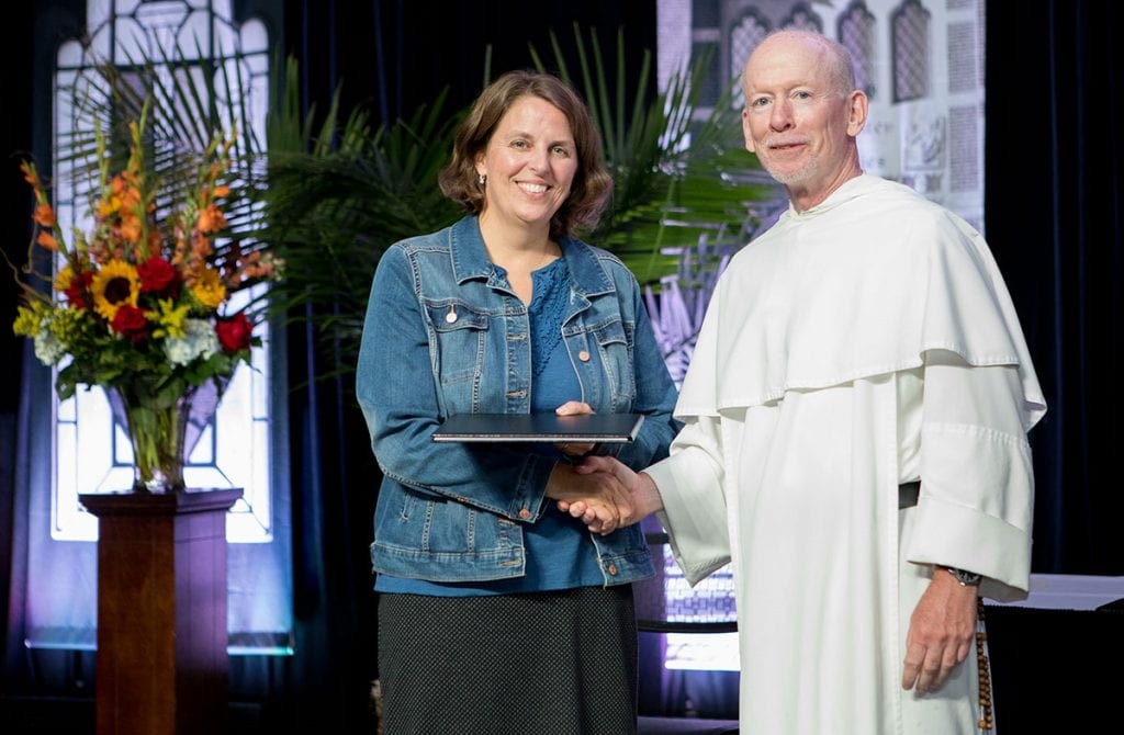Dr. Marcy Zipke is congratulated by College President Rev. Brian J. Shanley, O.P. '80, upon her promotion to professor of elementary and special education.
