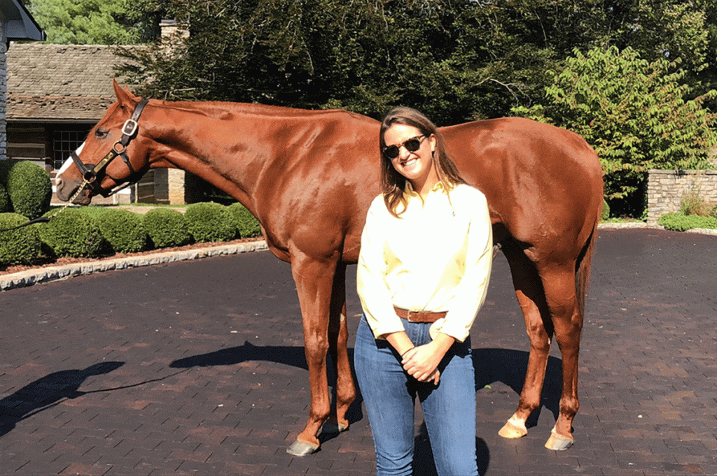 Shannon Kelly ’12 with 2018 Triple Crown winner Justify at Coolmore America Farm in Kentucky