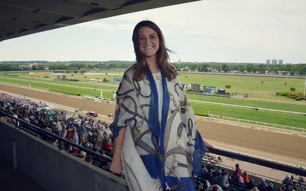 Shannon Kelly ’12 stands in the gallery at Belmont Park the day American Pharaoh won the Triple Crown in 2015.