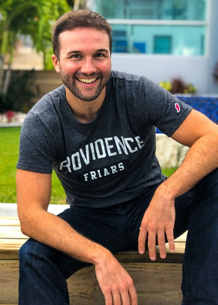 John Lee Dumas '02, sporting his Friars gear, served eight years in the Army (active duty and reserves), tried law school, and worked in finance in Boston, at a startup in New York, and in residential real estate in San Diego. 