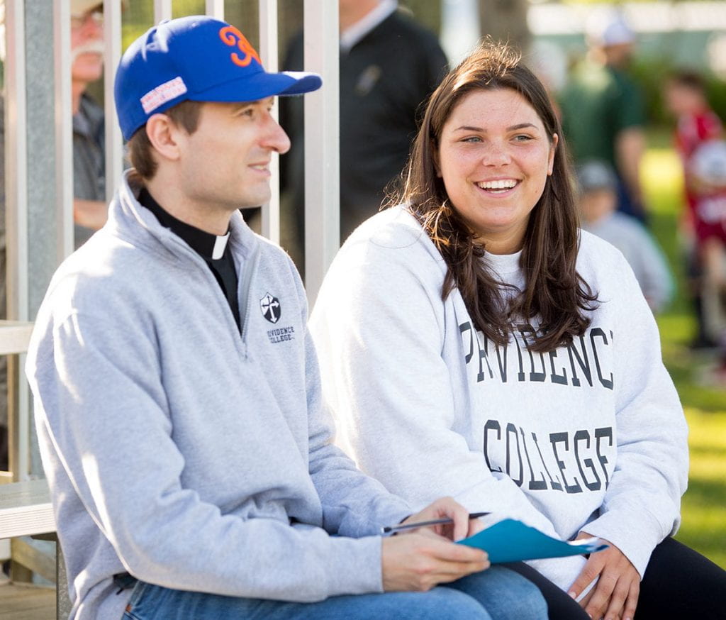 Erin O'Rourke '21, who interned with the Cape Cod League during the summer, takes in a game with her mathematics professor, Rev. Humbert Kilanowski, O.P.
