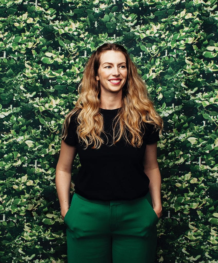 Jamilee Lacy, director and chief curator of PC Galleries, poses in front of "Victorian Ivy" a tapestry designed for PC’s collection by Sacramento artist Elizabeth Corkery. The fabric will be used to upholster panels upon which companion works will be displayed.