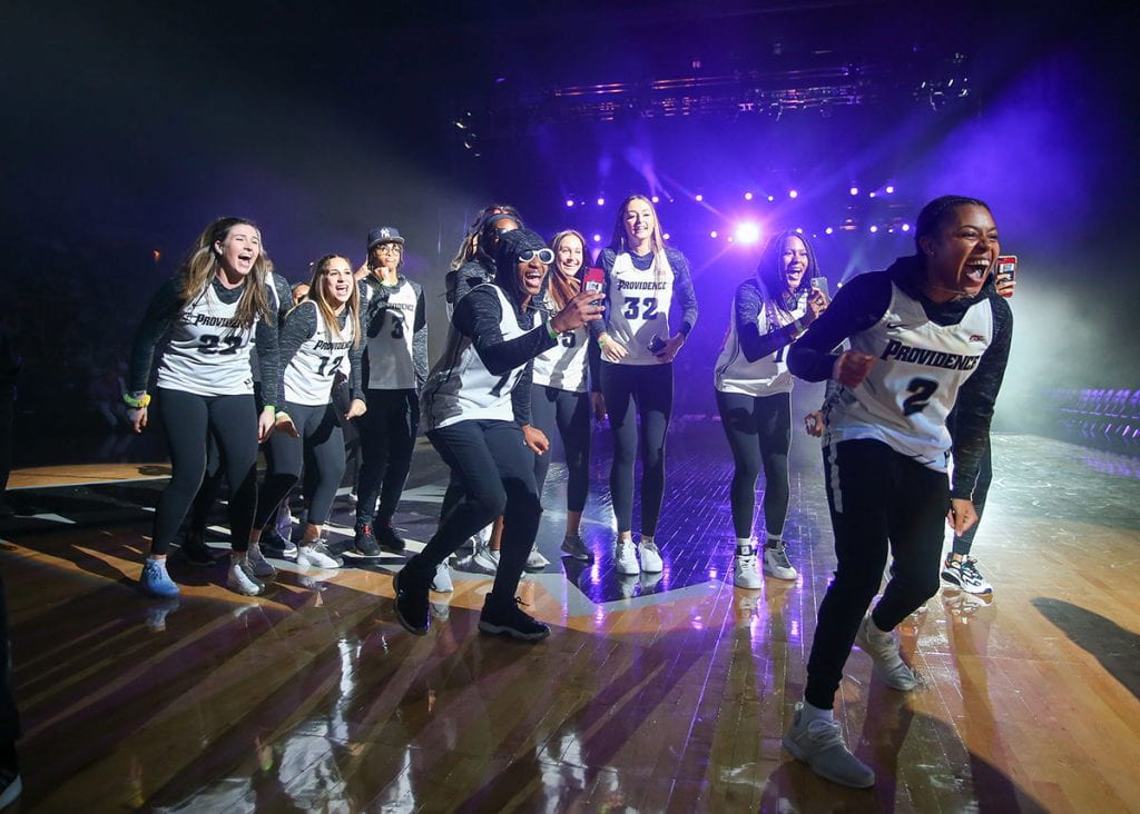 Women's basketball players celebrate at Late Night Madness at the Dunkin' Donuts Center.