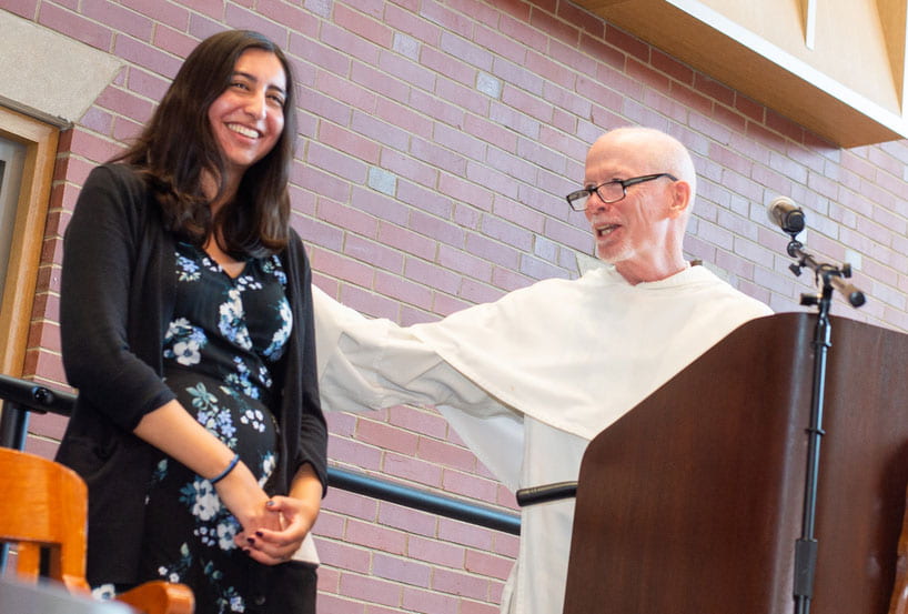 Nicole Jozwik '20, recipient of the Fiondella Student Academic Achievement Award, is congratulated by College President Rev. Brian J. Shanley, O.P. '80.