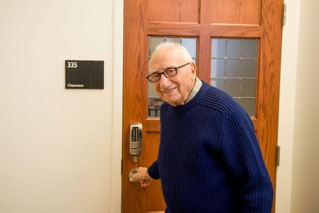 Dr. Joseph J. Box ’51 prepares to enter a Harkins Hall classroom for his School of Continuing Education course, Perspectives on Western Civilization. (Photo by Peter Goldberg)