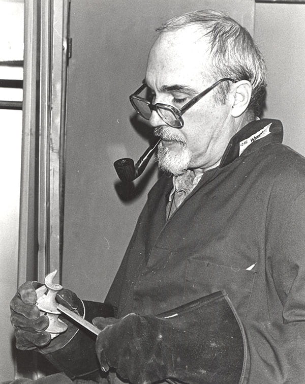 A pipe was a trademark of Father McAlister, seen here doing some filing.