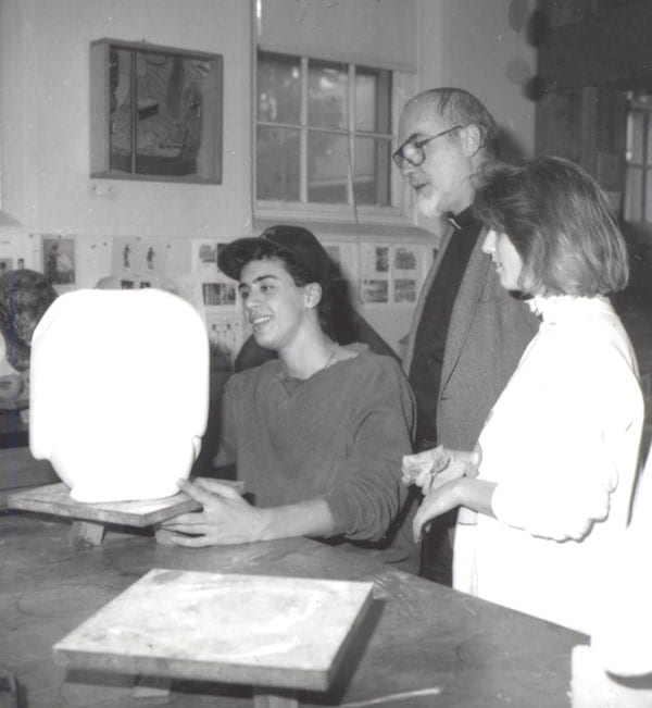 Father McAlister analyzes a sculpture with Timothy Jaccarino '92 and Kerri McGee '91 during a class.