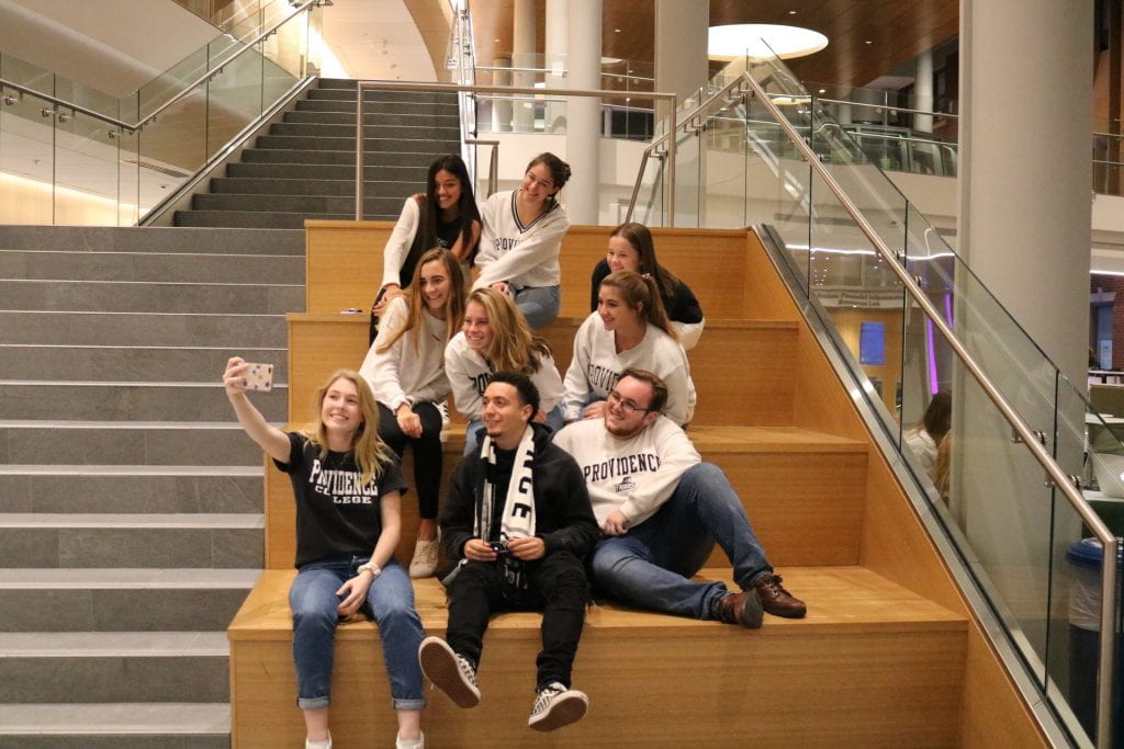 PC social media ambassadors take a selfie in the Ryan Center Atrium