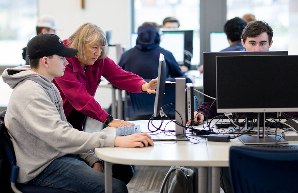 Faith Lamprey teaching Data Applications in Business to students in the new computer laboratory she made possible with a $500,000 gift to the College.