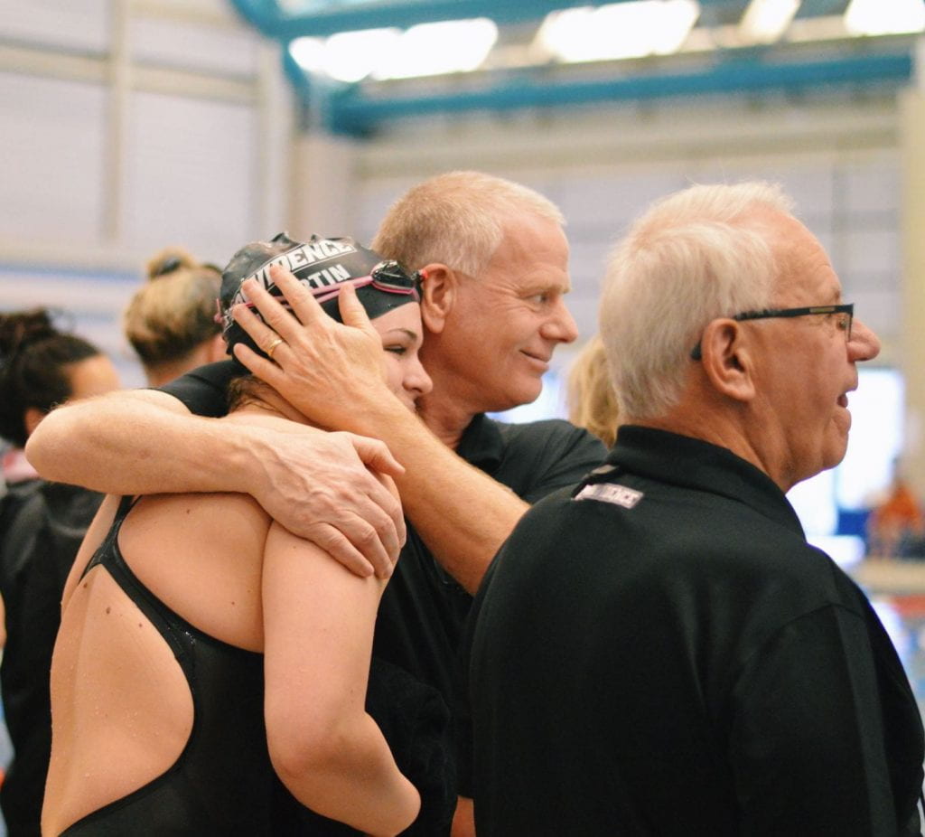 John ONeill, swim coach, hugs Colleen "CJ" McCartin 20 after her last race at the BIG EAST Tournament in February.