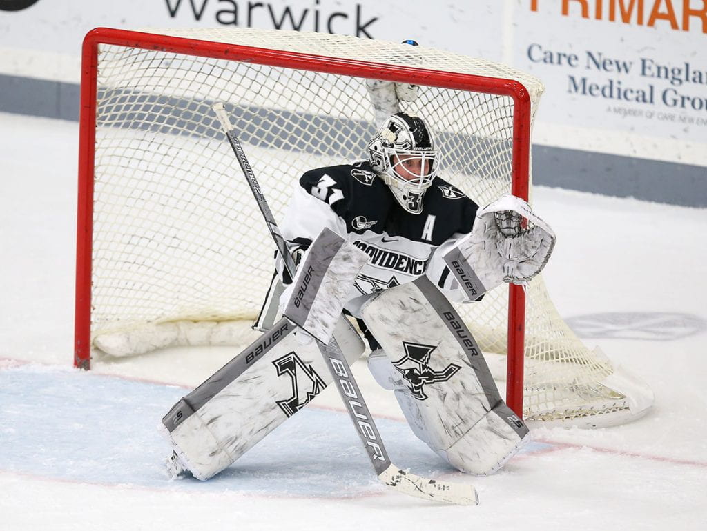 Clare Minnerath '20 in goal for the Friars, poised to make a save.