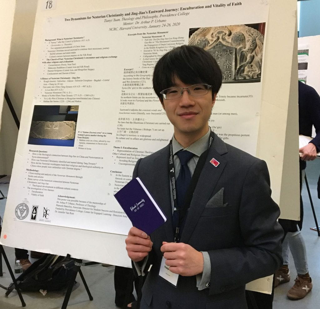 Tianyi Yuan '20 in front of the poster he presented during a conference at Harvard University.