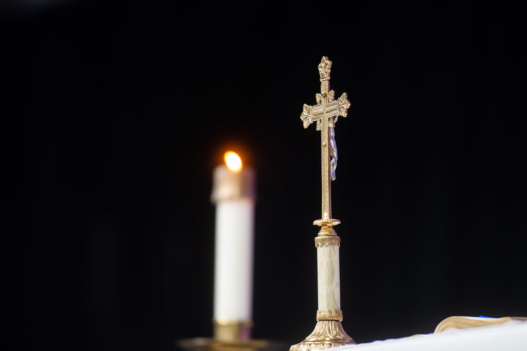 Candle and crucifix on the altar