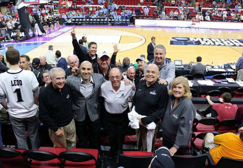 Joe ’65 and MaryBeth Canavan, right, get fired up with other Friar fans at the first-round NCAA Tournament game in Raleigh, N.C., in 2016. Others, from left, are trustee Joseph M. Calabria, Jr. ’65, Steve Napolillo ’98, and Gerald Marsocci, M.D. ’63. Behind Napolillo is Kerry I. Rafanelli, Esq. ’80 (in white cap) and behind Mr. Canavan is Frank Richard ’70.