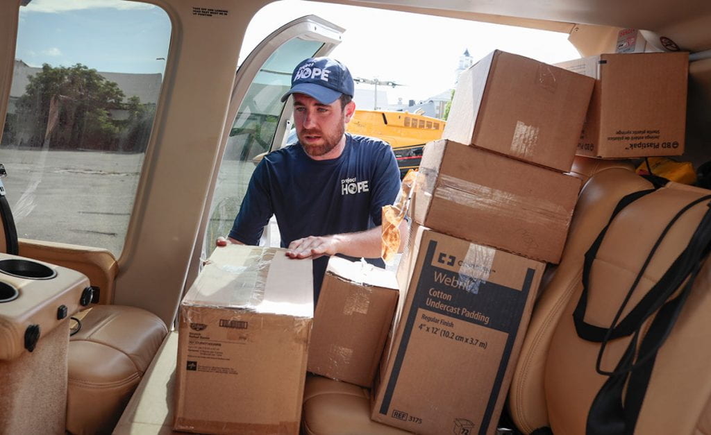 Tom Cotter '10 loads supplies into a vehicle after Hurricane Dorian hit the Bahamas in late summer 2019.