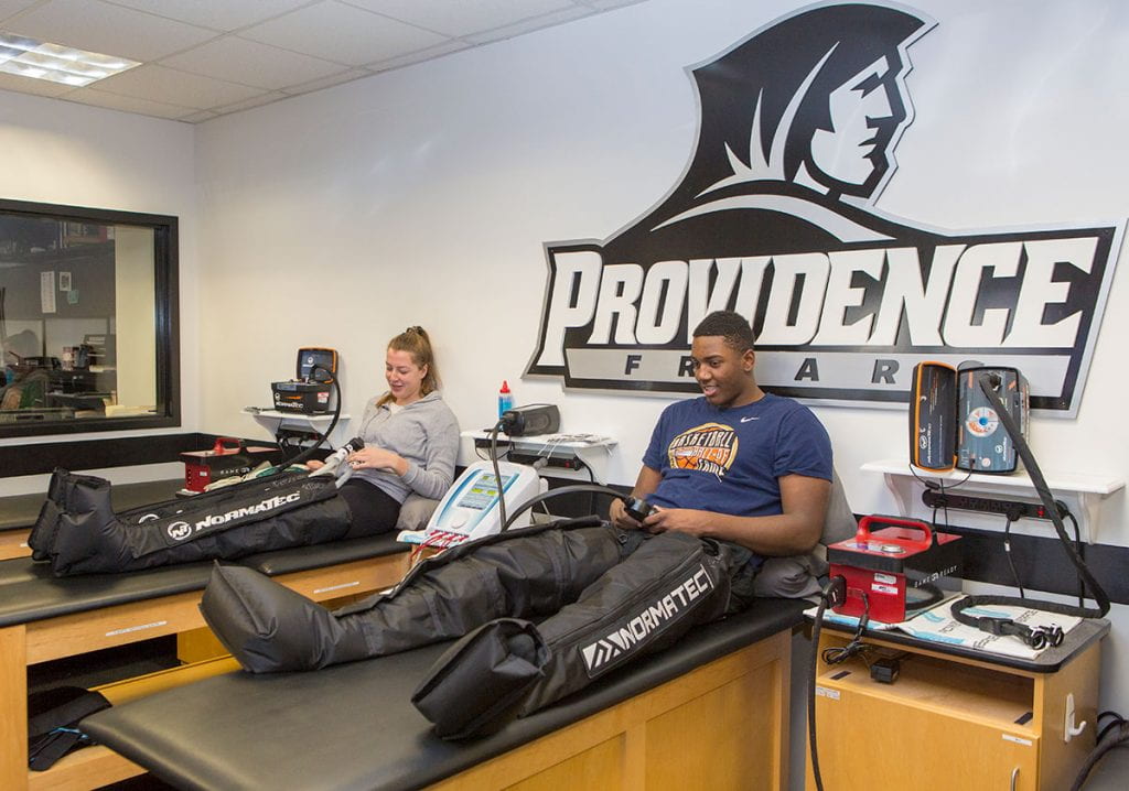 Floor Rozemeijer ’20 of the field hockey team, left, and Kalif Young ’20 of the basketball team receive treatment in the Canavan Sports Medicine Center in 2017. They are being treated with NormaTec compression-boot systems, made possible by a gift from Mr. and Mrs. Canavan.