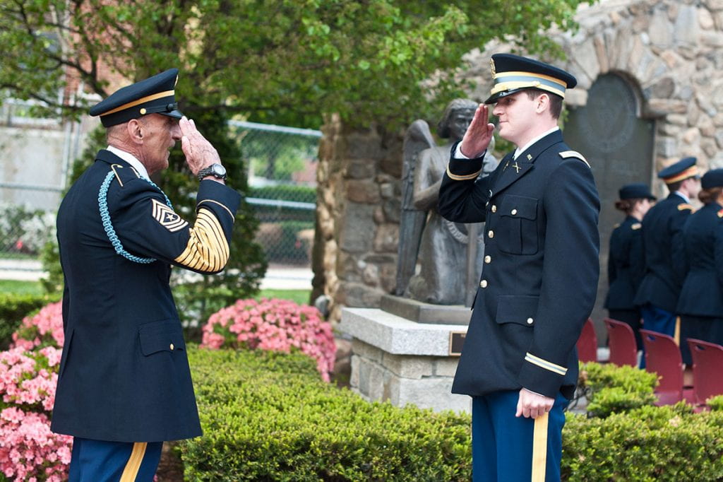 First Lt. Evan Bolton ’15, right, makes his first salute to Sgt. Major Fortunato during ROTC Commissioning Exercises in May 2015. One Patriot Battalion associate estimated that two-thirds of the newly commissioned lieutenants asked Sgt. Major Fortunato to be the recipient of their first salute during his 23 years at PC.