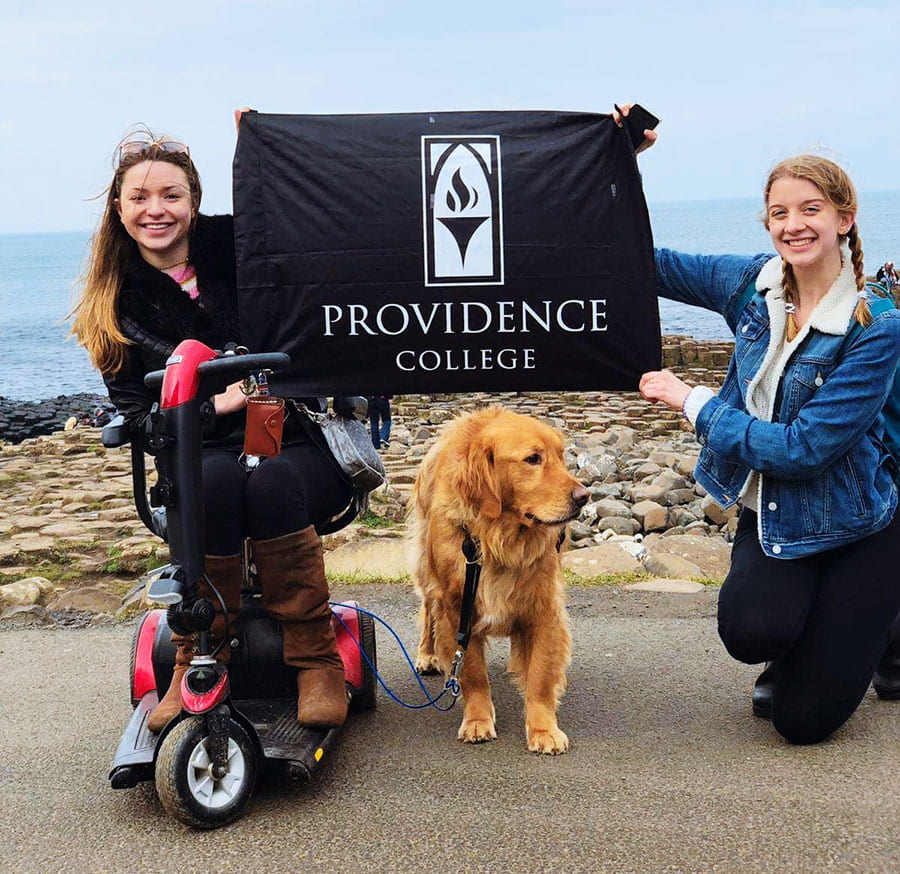 Jacquie Kelley '20, left, and Julia Gaffney '20 hold a Providence College flag during their semester abroad in Ireland.